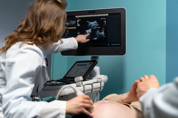 Gynecologist performing abdominal ultrasound scan on a female patient during a routine health checkup.