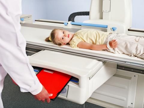 Medical X-ray machine scanning a patient with protective measures in a diagnostic center